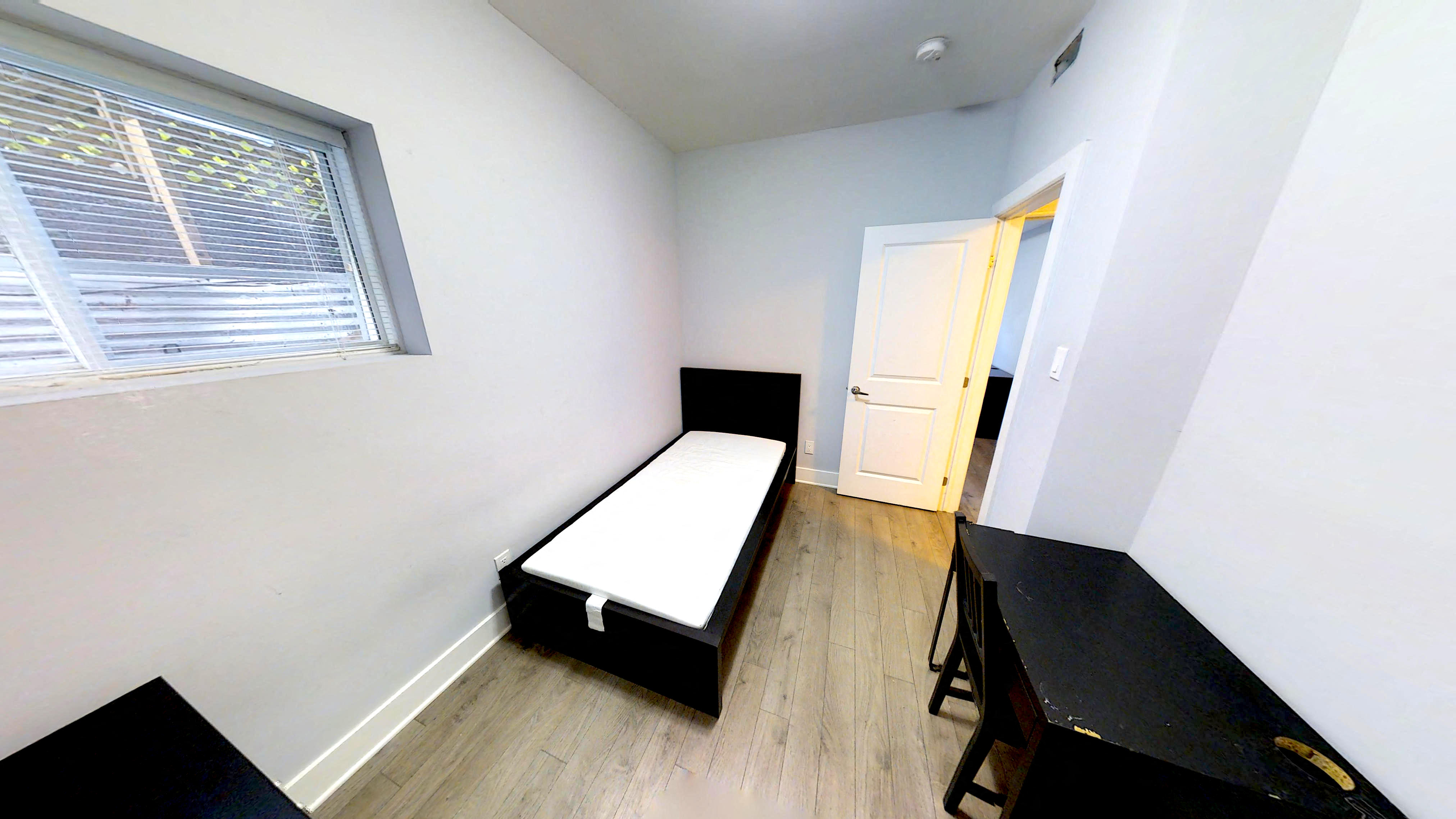 an empty room with a bed and a table